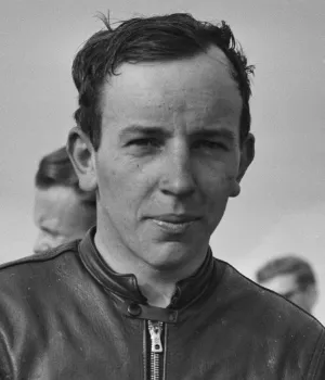 John Surtees, the only motorsport champion on two and four wheels, winning the 1964 F1 title with Ferrari.